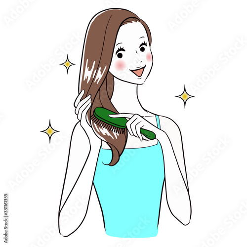 Beautiful woman Brushing Her Hair smiling.