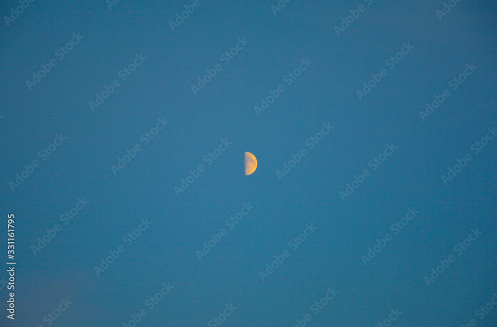 Half moon in blue sky Half moon in blue sky