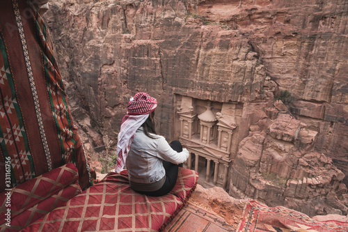 A woman enjoy view of Amman capital city of Jordan, Arab sitting in front of the Treasury in Petra ruin and ancient city in Jordan, Arab