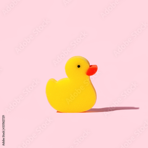 Bilde på lerret Yellow toy duck sponge or washcloth on pink background