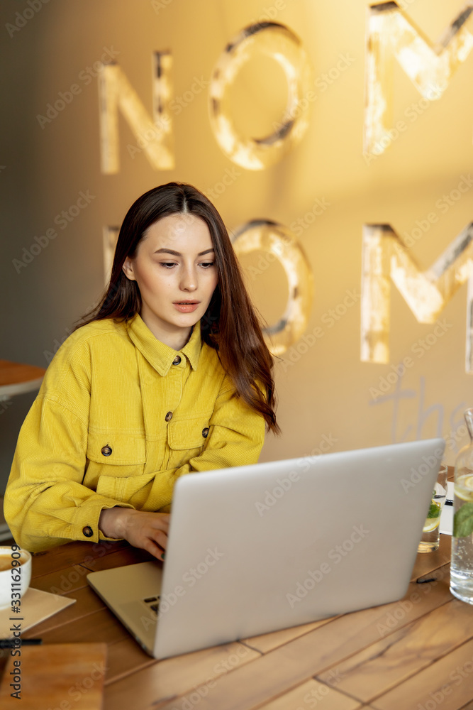 Attractive girl working on laptop during lunch time Attractive girl working on laptop during lunch time