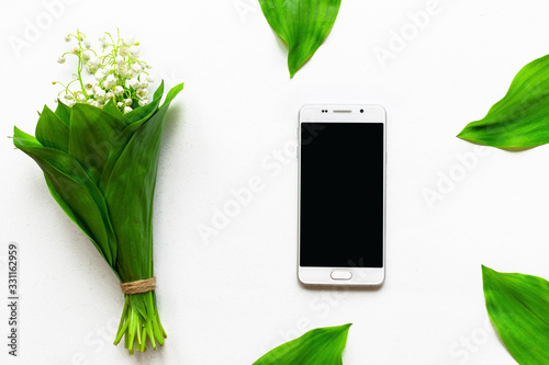 screen smartphone and flowers on white background photo