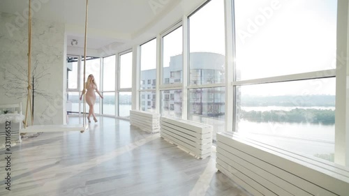 Woman walks in heels in the bedroom, she is sexy and erotically stroking herself.