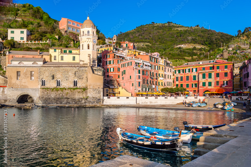 Vernazza, Cinque Terre - beautiful village with colorful buildings and church near sea. Cinque Terre National Park with cliffs and hiking trails is famous tourist destination in Liguria, Italy