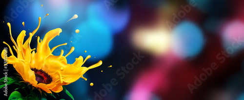Splashing petals of a liquid sunflower with colorful bokeh background