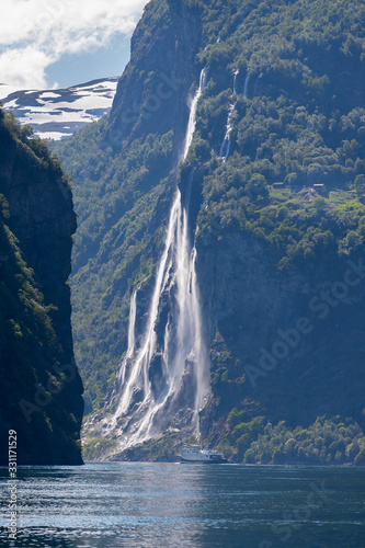 GEIRANGER, NORWAY - 2016 JUNE 14. Fjord1 ferry under the Seven Sister Waterfalls inside the Norwegian fjord Geiranger. photo