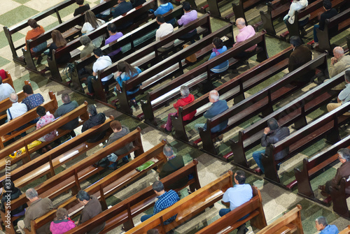 People sitting in the banks inside the church