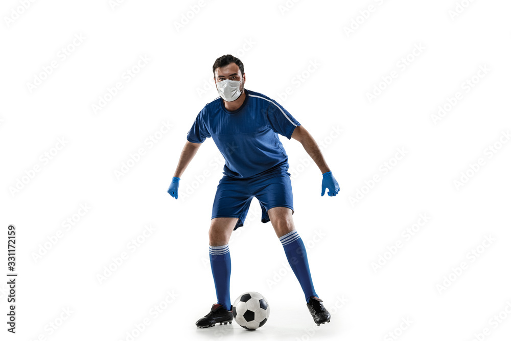 Beat the disease. Male football, soccer player in protective mask. Prevention against pneumonia. Still active while quarantine. Chinese coronavirus treatment. Healthcare, medicine, sport concept.