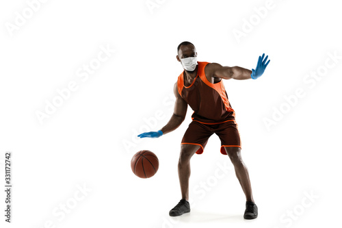 Beat the disease. Male basketball player in protective mask. Prevention against pneumonia. Still active while quarantine. Chinese coronavirus treatment. Healthcare, medicine, sport concept.