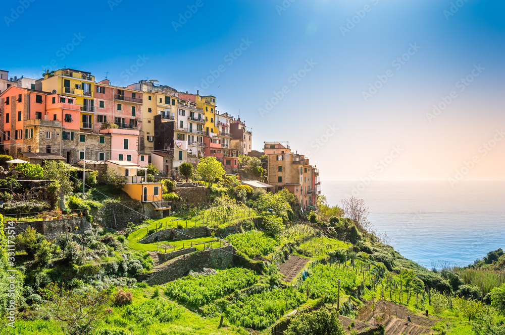 Corniglia, Cinque Terre - beautiful small village with colorful buildings on the cliff overlooking sea. Cinque Terre National Park with rugged coastline is famous tourist destination in Liguria, Italy