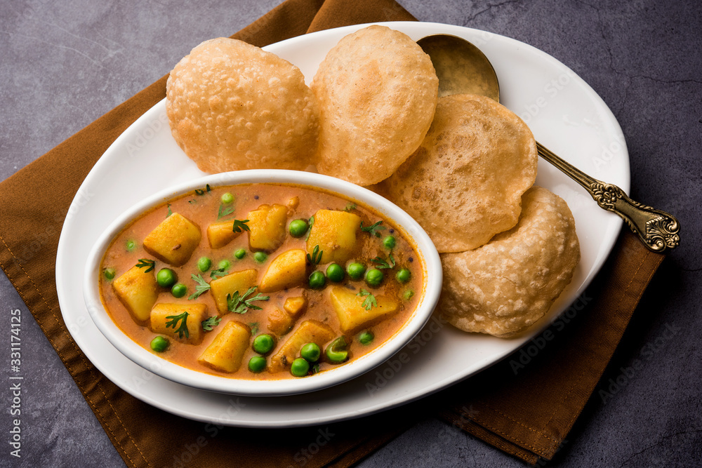 Aloo Puri or Potato curry with fried Poori, popular Indian breakfast / lunch / dinner menu.