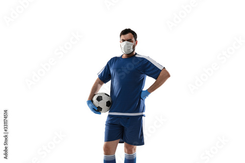 Punching virus. Football, soccer player in protective mask and gloves. Prevention against pneumonia. Still active while quarantine. Chinese coronavirus treatment. Healthcare, medicine, sport concept. © master1305