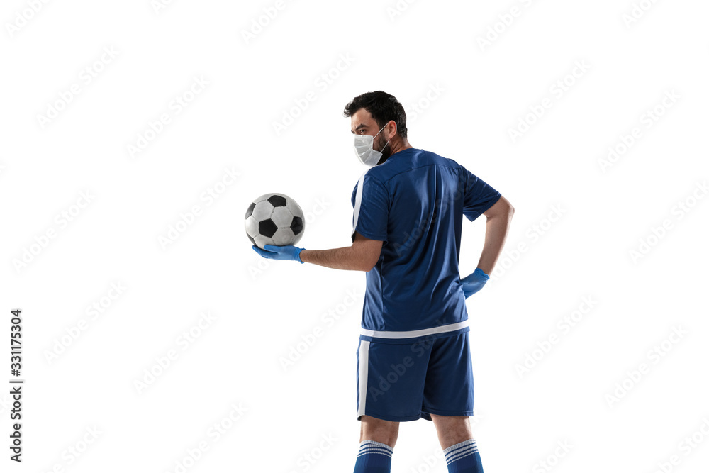 Punching virus. Football, soccer player in protective mask and gloves. Prevention against pneumonia. Still active while quarantine. Chinese coronavirus treatment. Healthcare, medicine, sport concept.