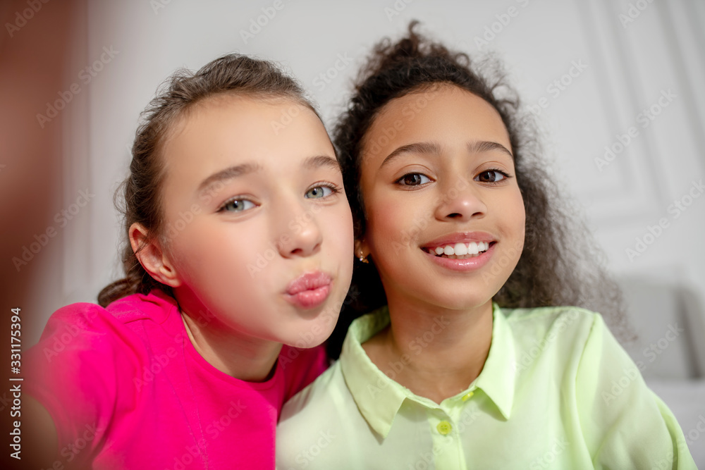 Cute girls making selfie and sending air kiss Cute girls making selfie and sending air kiss
