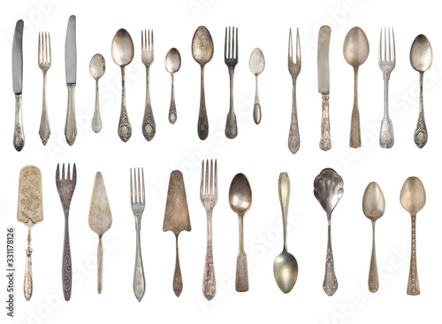 Collection of beautiful old vintage forks, spoons and knife isolated on white background. Top view. Retro silverware.