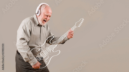 Excited senior playing imaginary guitar