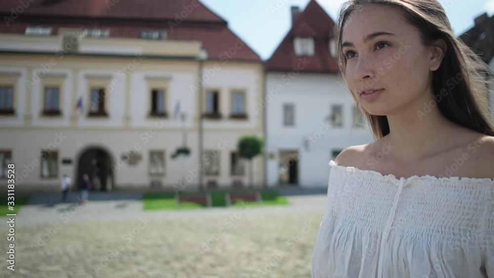 Girl enjoying summer day and walking alone in town Girl enjoying summer day and walking alone in town