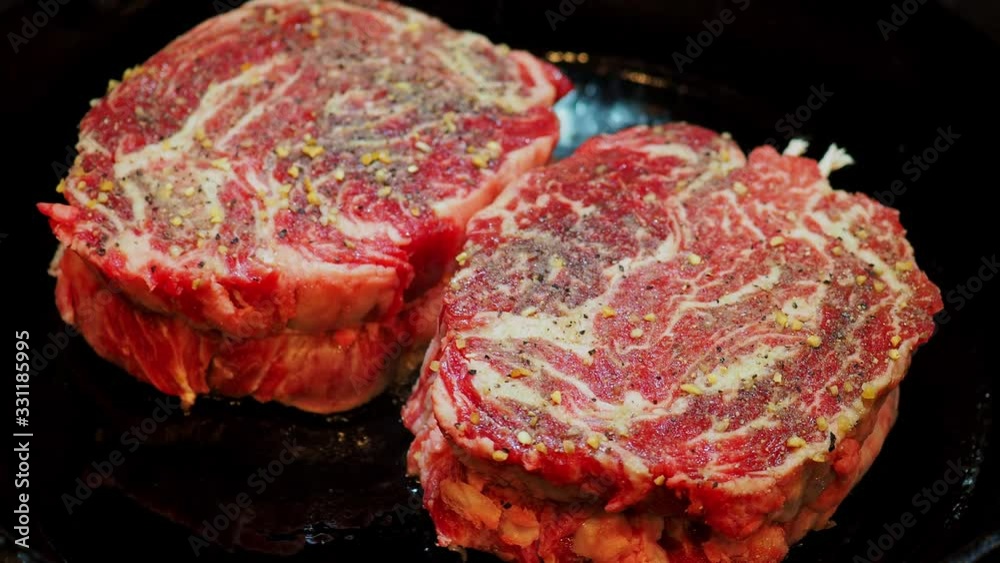 Close up shot of frying the delicious Prime Rib Eye Cap on a cast iron pan