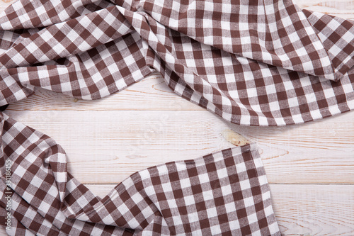 Tablecloth napkin on wood texture. Rustic background. top view.