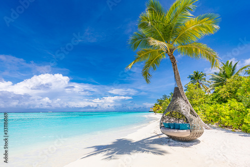 Tropical beach background as summer landscape with beach swing or hammock and white sand and calm sea for beach banner. Perfect beach scene vacation and summer holiday concept. Boost up color process