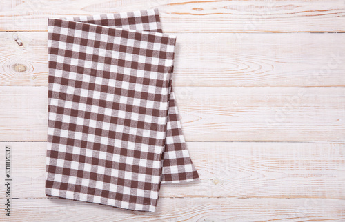 Tablecloth napkin on wood texture. Rustic background. top view.