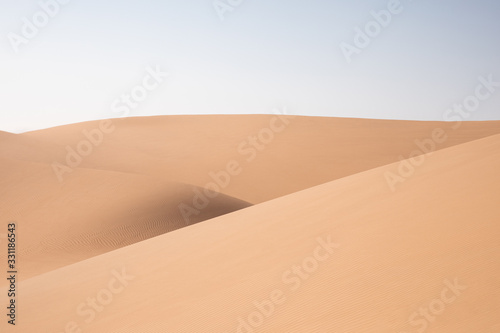 Abstract landscape with desert dunes on a sunny day. Liwa desert, Abu Dhabi, United Arab Emirates.