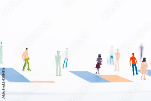 Selective focus of people figures on surface with graphs isolated on white, concept of equality
