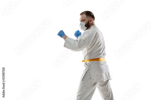 Take off the corona. Martial arts fighter in protective mask, gloves. Prevention against pneumonia. Still active while quarantine. Chinese coronavirus treatment. Healthcare, medicine, sport concept.