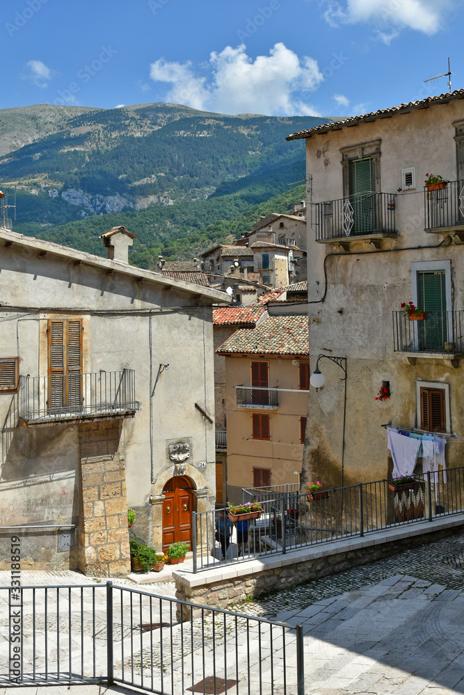 A narrow street between the old houses of a medieval village in Abruzzo A narrow street between the old houses of a medieval village in Abruzzo