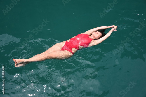 View from above as a girl swims in the open Adaman Sea