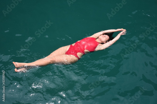 View from above as a girl swims in the open Adaman Sea