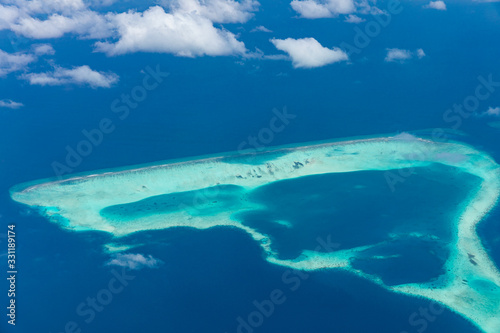 Maldives aerial view with atolls and islands. Amazing view from seaplane or drone, luxury vacation travel scenery © icemanphotos