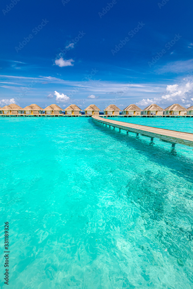 Maldives beach resort panoramic landscape. Amazing summer landscape with lagoon, blue sea and wooden jetty to water bungalows. Luxury vacation and travel landscape background
