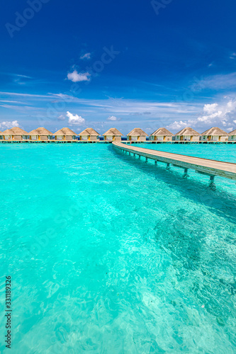 Maldives beach resort panoramic landscape. Amazing summer landscape with lagoon, blue sea and wooden jetty to water bungalows. Luxury vacation and travel landscape background © icemanphotos