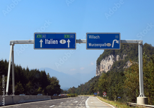 Road sign near the border between Italy and Austria and Slovenia photo