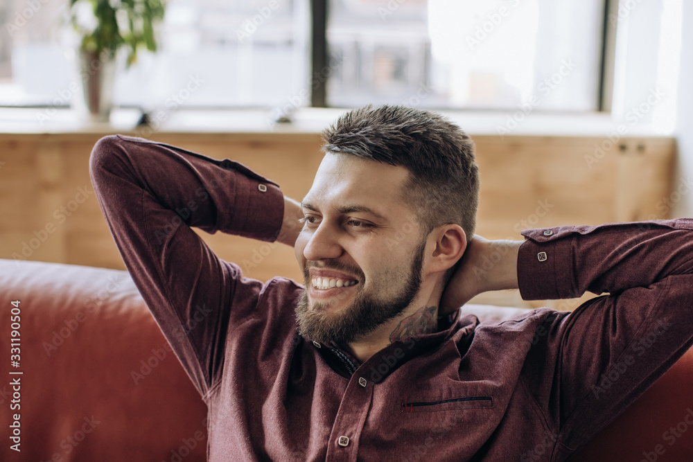 Young bearded man smiling after hard work Young bearded man smiling after hard work