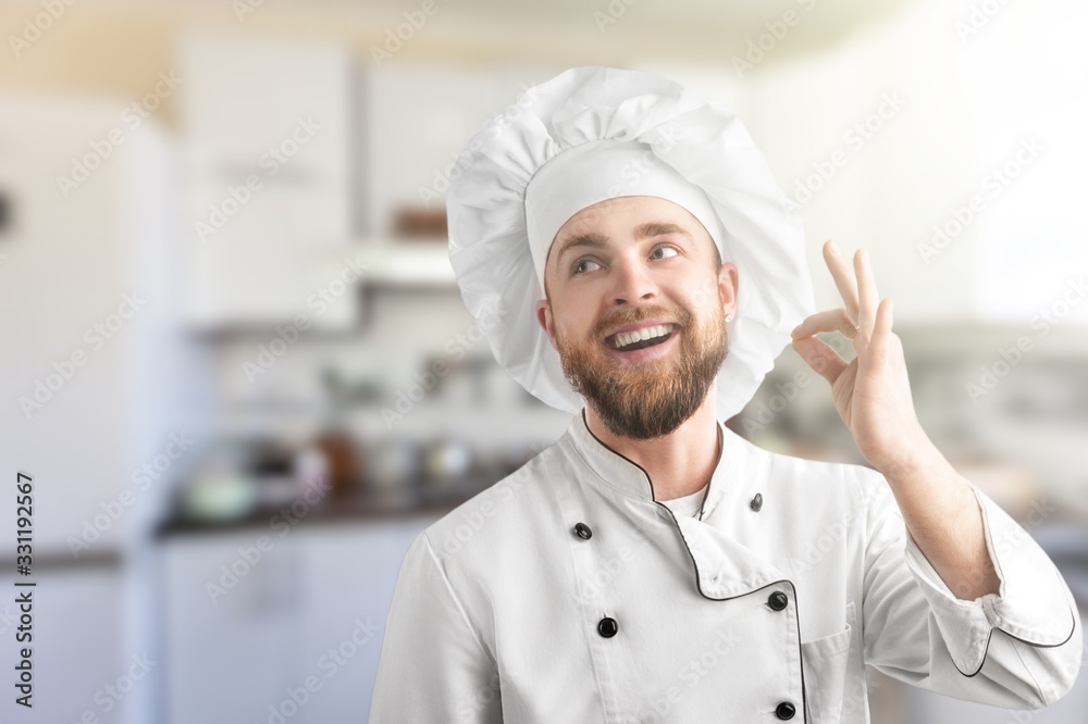 Professional chef man in uniform showing sign for delicious. Professional chef man in uniform showing sign for delicious.