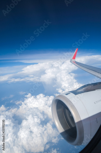 A wing in the window of an AirAsia plane .
