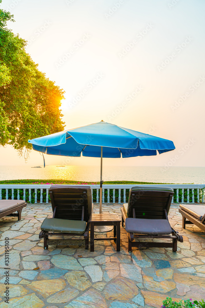 beach chair or pool bed with umbrella around swimming pool