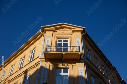 Old tenement house illuminated by bright sun light.