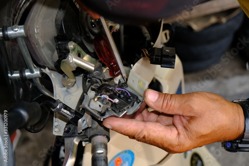 Motorcycle repair technicians check the wiring or repair of the motorcycle.