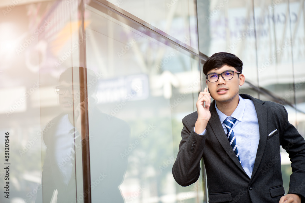 Young businessman running while talking on the mobile phone during rush hour. Business rushing concept. Young businessman running while talking on the mobile phone during rush hour. Business rushing concept.