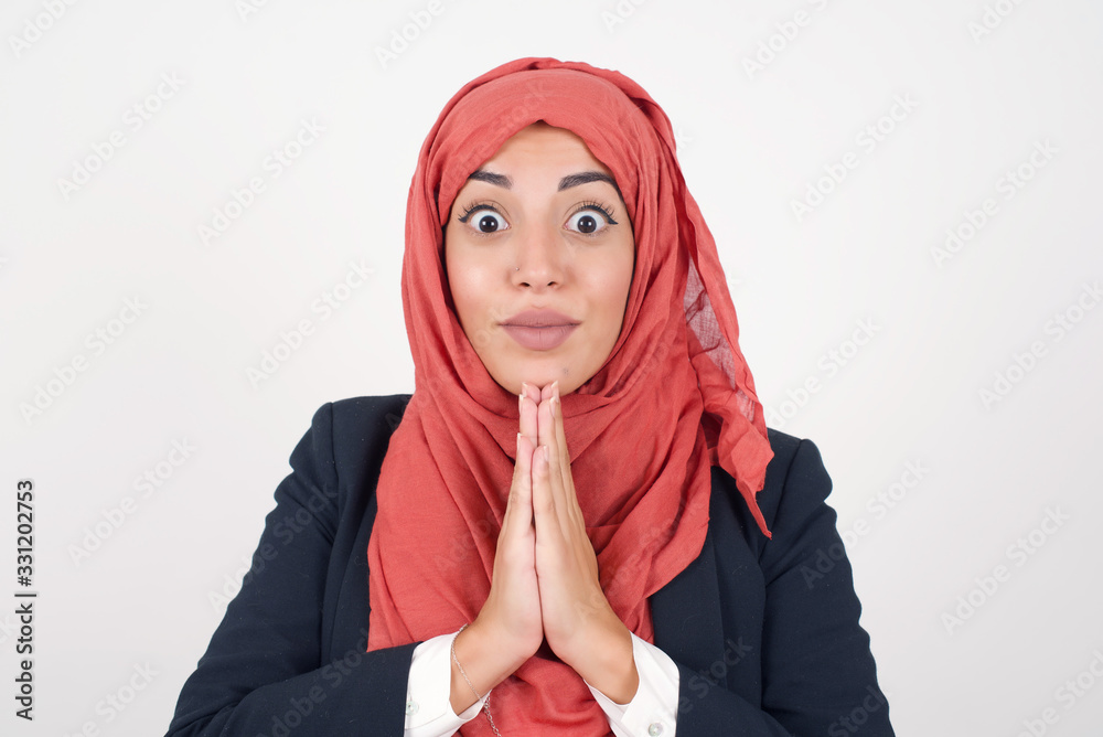 Horizontal portrait of pretty blonde woman keeps palms together, has pleased expression. Glad attractive female makes request, pleads for mercy. Hopeful young adult. Horizontal portrait of pretty blonde woman keeps palms together, has pleased expression. Glad attractive female makes request, pleads for mercy. Hopeful young adult.
