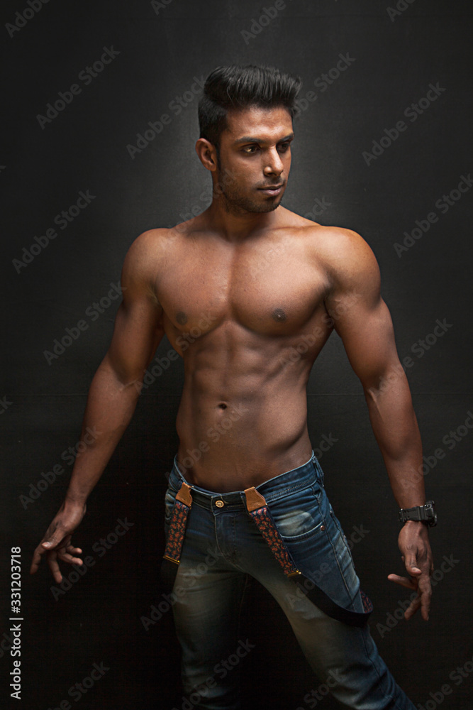 Tanned trainer body builder posing athletic body