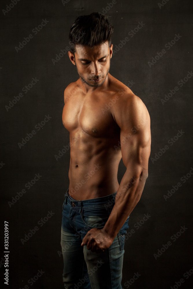 Tanned trainer body builder posing athletic body
