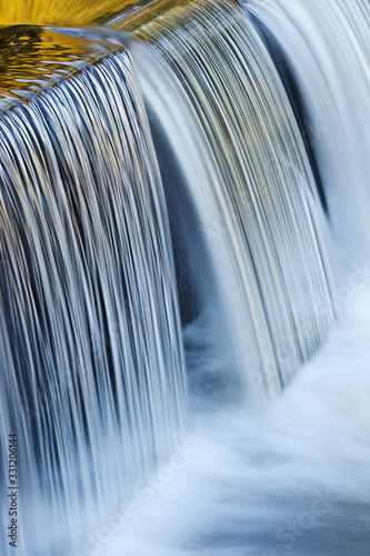 Landscape of the Portage Creek Cascade captured with motion blur and illuminated by reflected color from blue sky overhead, Milham Park, Kalamazoo, Michigan, USA