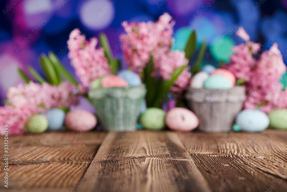 Easter background. Rustic wooden table. Tulips and spring flowers. Easter eggs. Pastel colors bokeh. Easter background. Rustic wooden table. Tulips and spring flowers. Easter eggs. Pastel colors bokeh.