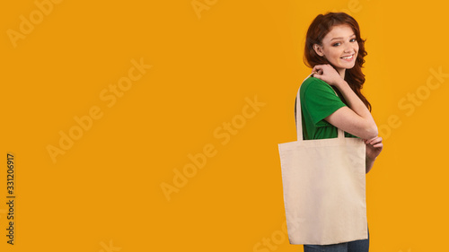Teen Girl Holding Blank Eco Bag On Yellow Background, Panorama
