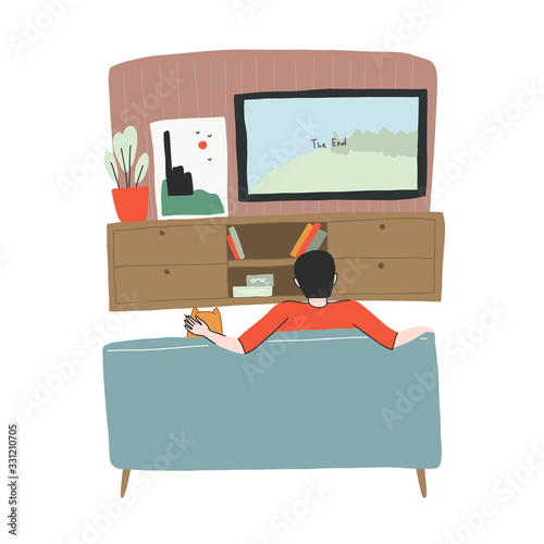 Young man is watching TV with his dog on the sofa