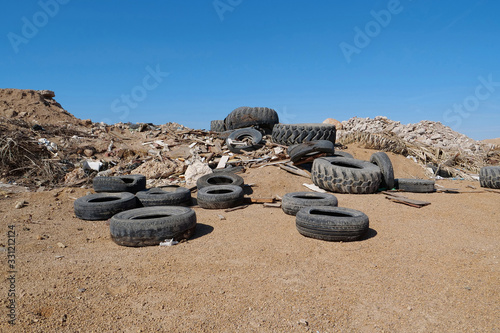 Old tyres and other garbage lies on landfill photo